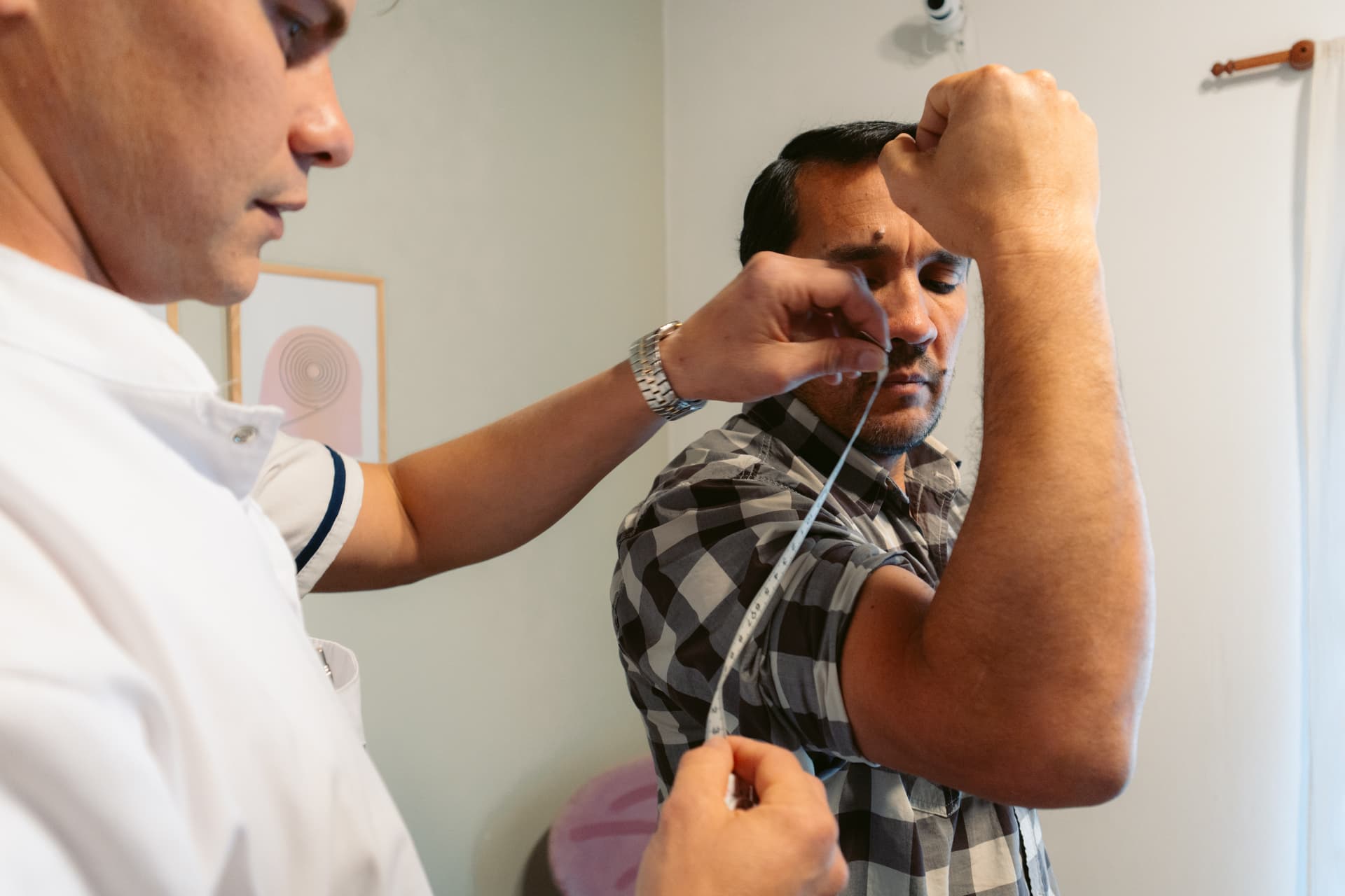 Hernán Vecchia, Lic. en Nutrición, realiza una medición con cinta métrica durante una consulta en el consultorio de Centro ANPI.